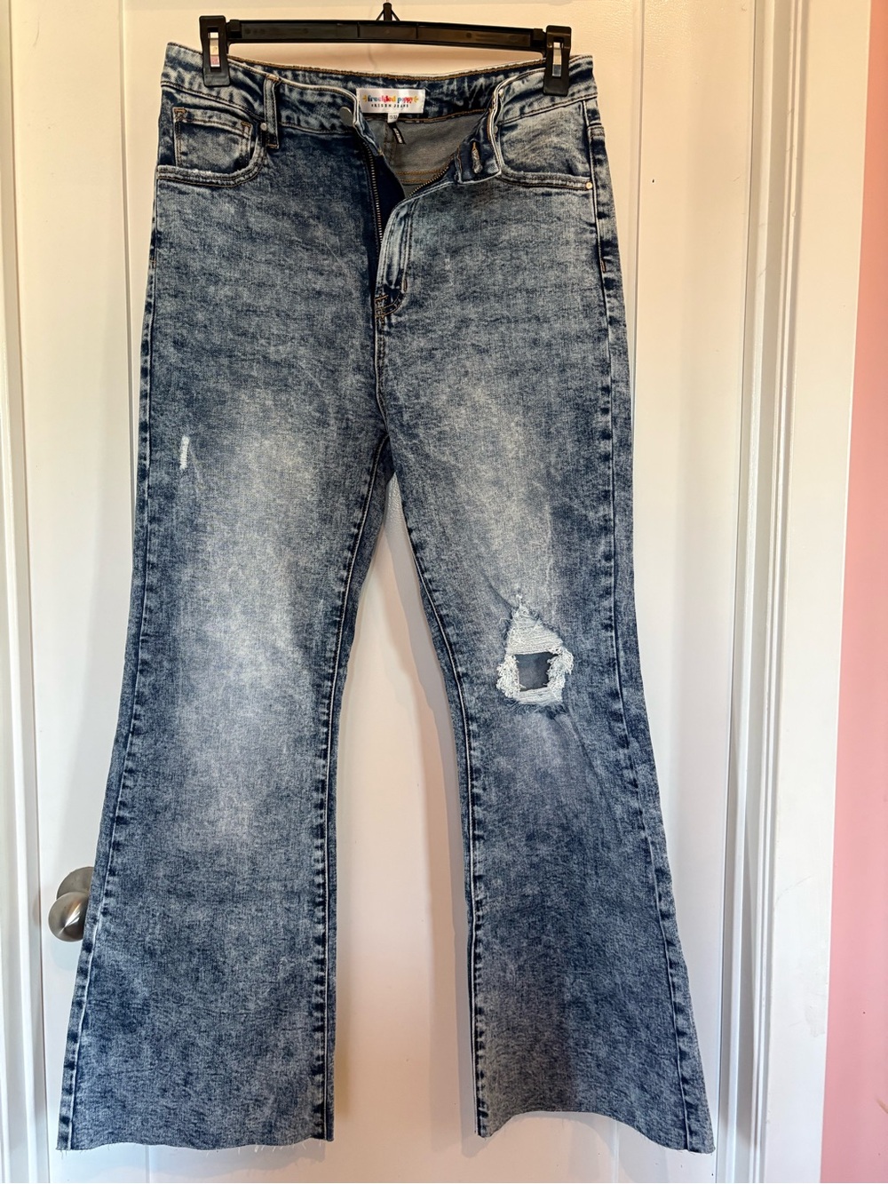 High-Rise Acid Wash Blue Flare Jeans with Knee Distress and unfinished hem
